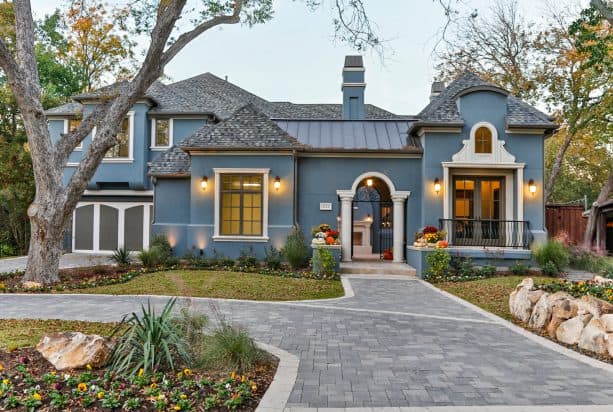 creating a unique exterior design with the combo of greyish blue stucco and white trim