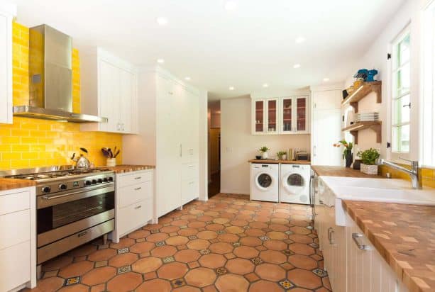 saltillo floor tile in terracotta color combined with white cabinets to enhance tuscan style