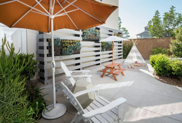 slatted patio walls are used to mount hanging gardens