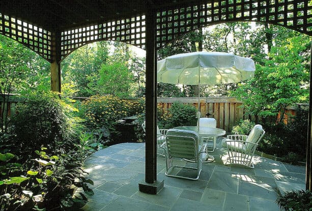 partial sun townhouse backyard stone patio under the deck