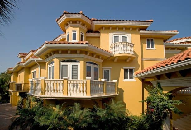 the use of yellow stucco and white trim in Mediterranean exterior