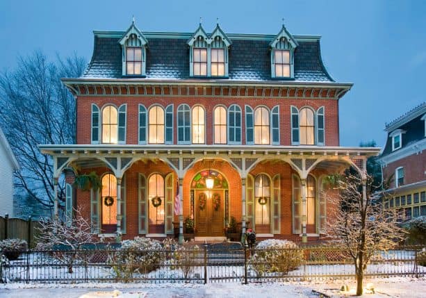 victorian house with a touch of gothic style in a red brick and hunter green shutters