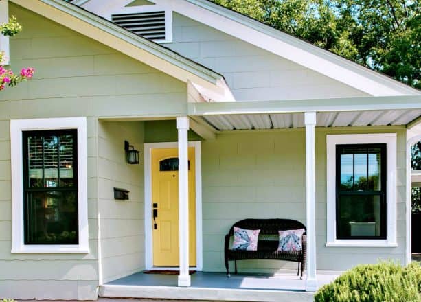 mint green siding as a background and butter yellow door as an accent