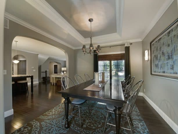 traditional living room with grey walls, white trims, and dark hardwood floor