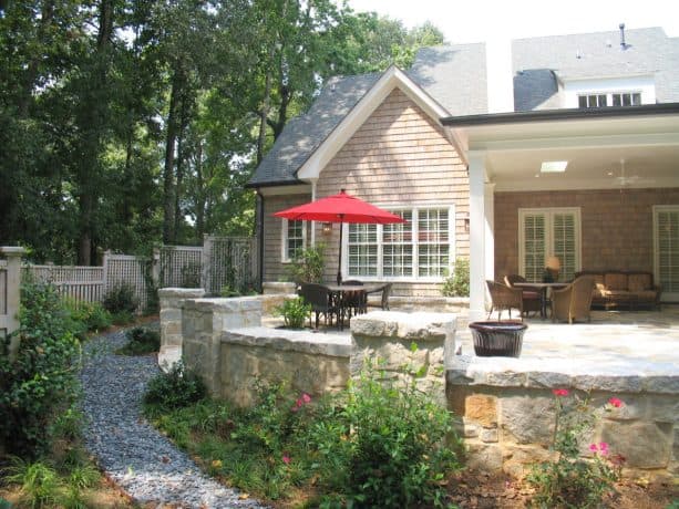 bluestone flooring in an extended patio in a grassless front yard