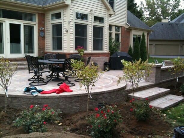 a traditional raised patio made of pavers and edged with bricks