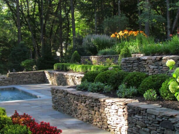 pennsylvania fieldstone tiered retaining wall around the bluestone patio