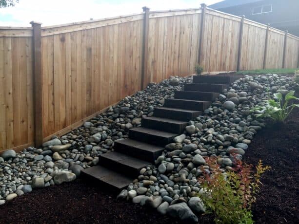 dark stone steps in a rock low maintenance hillside landscaping