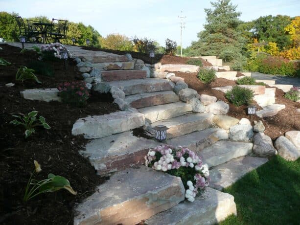 hillside landscaping with stone steps and low-maintenance plants