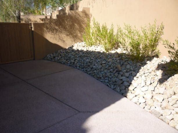 a decorative rip rap retaining wall for a contemporary patio