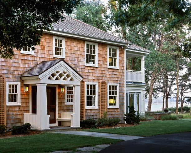 decorative front door portico with an arched lattice and built-in benches in the columns