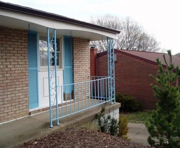 light blue wrought iron columns create a beautiful pop at a front porch