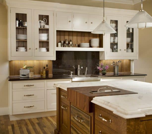 darker wood backsplash paired with cream kitchen cabinets