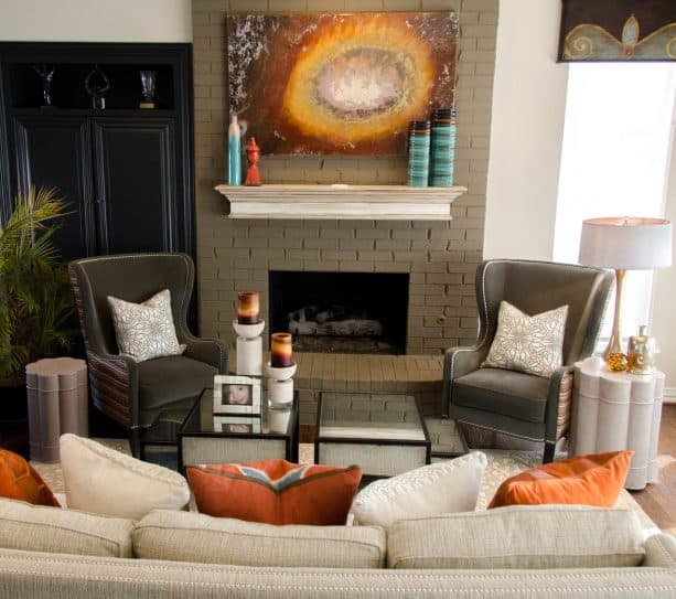 eclectic family room with tall greige brick fireplace