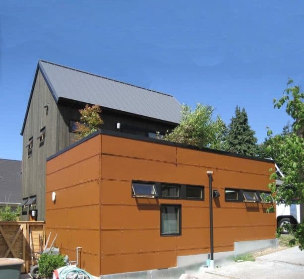 brown metal building with awning and picture windows