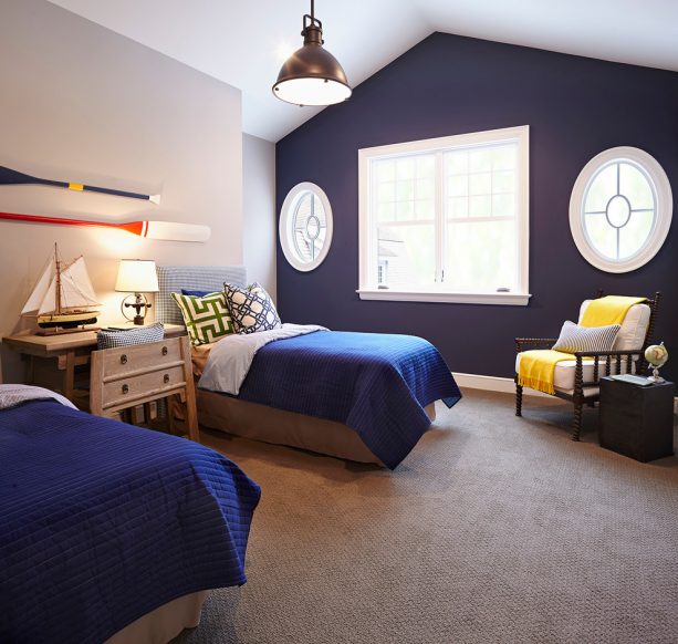 navy blue-dominated bedroom with bright yellow throw blanket