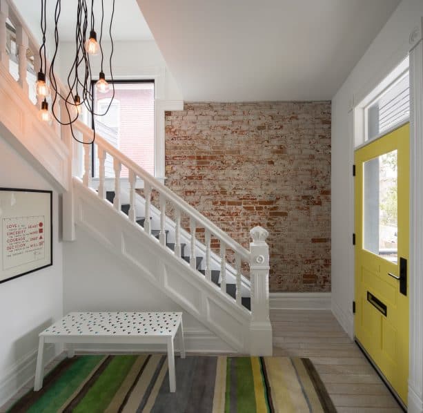 single yellow front door with white walls