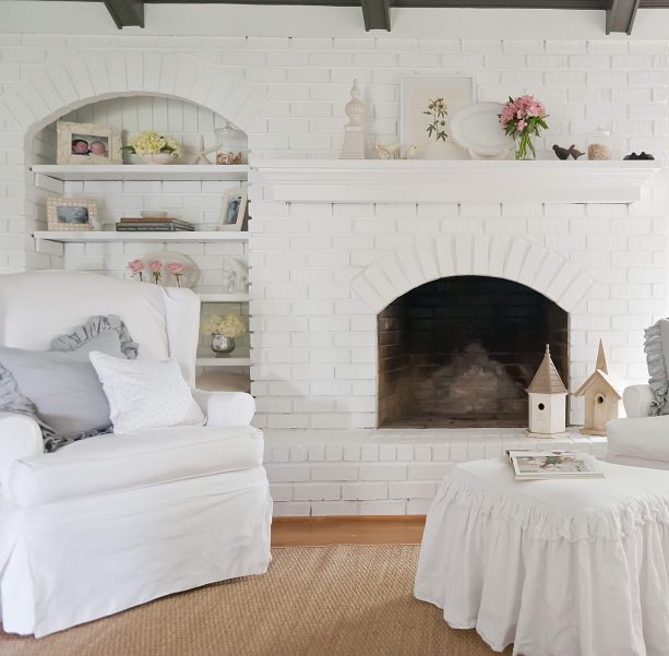 chic living room with white brick fireplace and wall