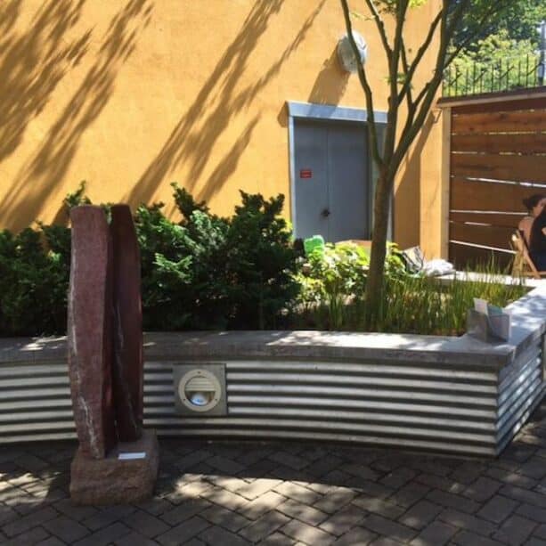 corrugated metal retaining wall with a concrete cap