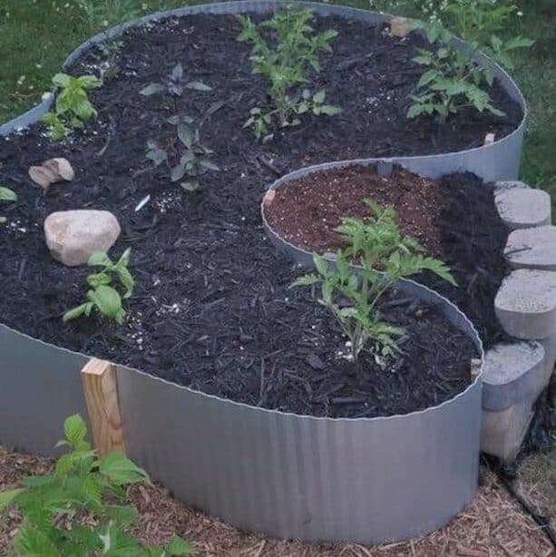 corrugated metal retaining wall as an edging with hemmed edges