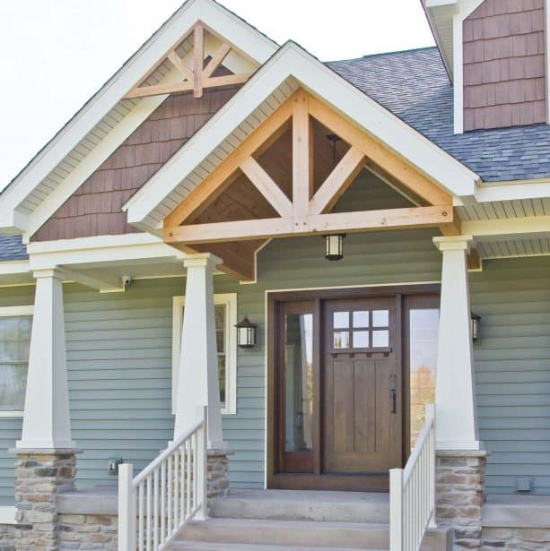 coffee brown front door combined with green siding