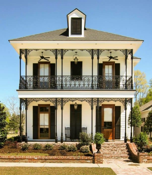 lanky wrought iron columns add a pleasant look to the porch of a two-story house