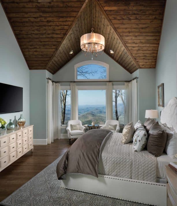 bluish grey wall with hickory wood floor in a traditional bedroom