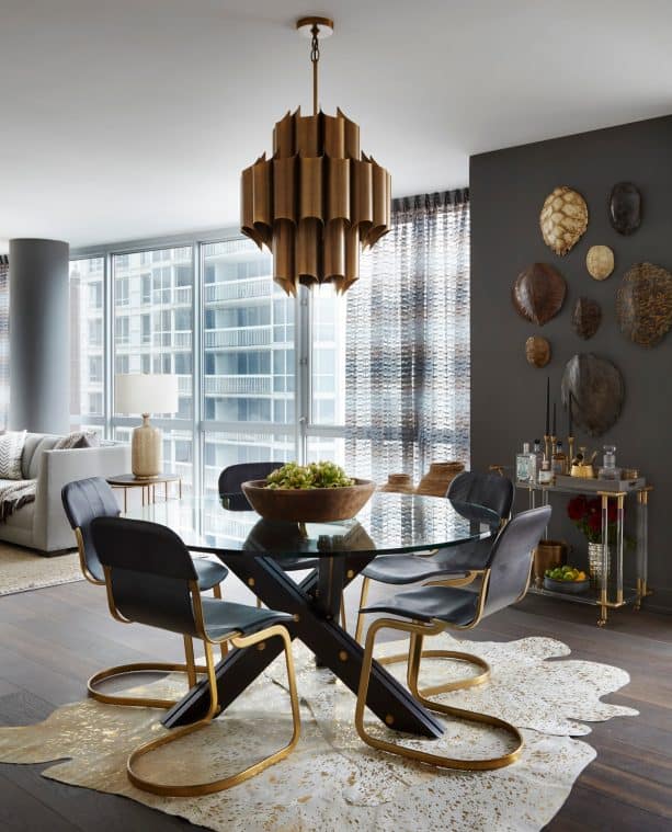 white and gold cowhide area rug in a black dining room