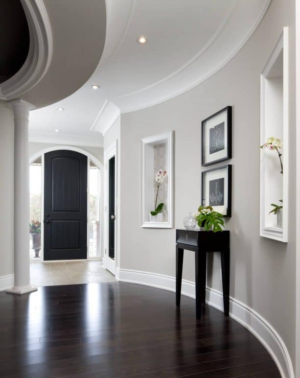 transitional hall with grey walls and dark-stained prefinished hardwood floor