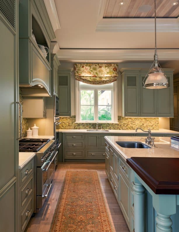 vintage kitchen with medium-toned wood floor and sage green cabinets