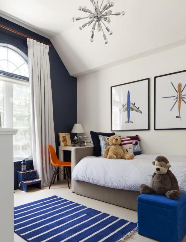 a kid's room with navy blue and beige color scheme