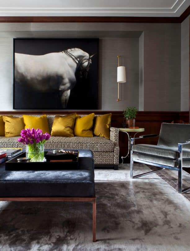 cozy living room with gray silk rug and gold plush pillows