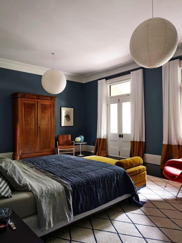 navy blue-dominated bedroom with wood cupboard