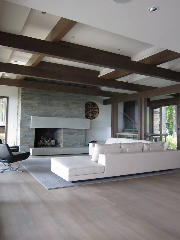 wall-size fireplace surround from gray blue limestone paired with white oak wood floor