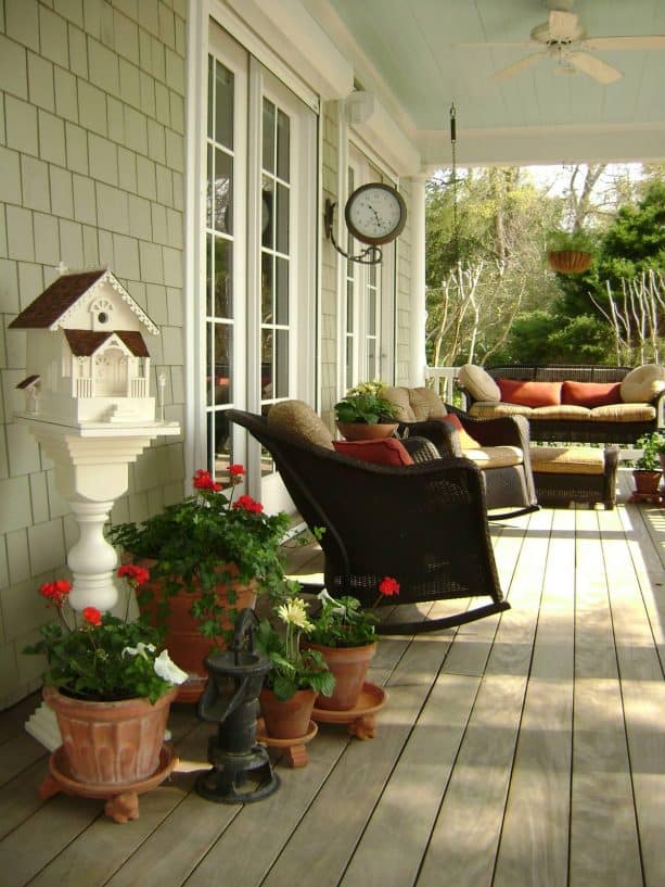 a sage porch with welcoming red decorations