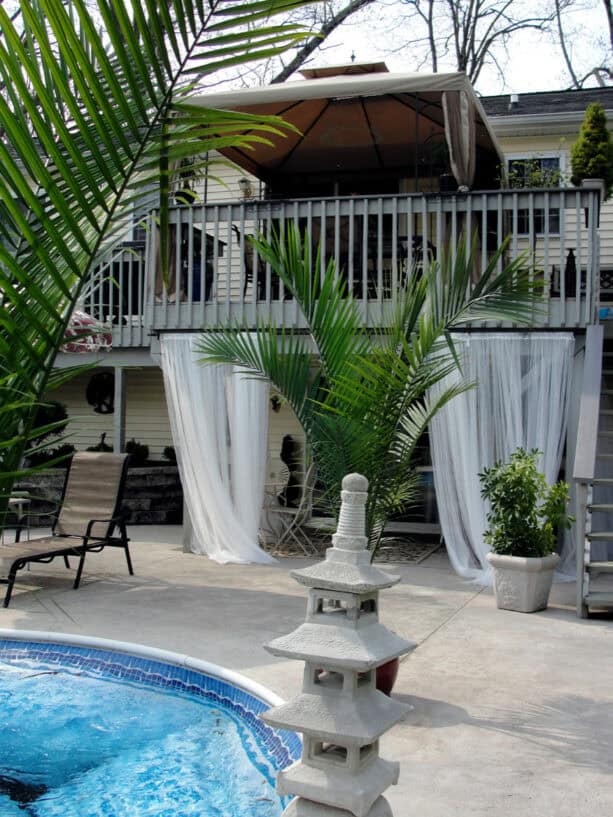 cabana seating area in an under deck patio completed with drapery