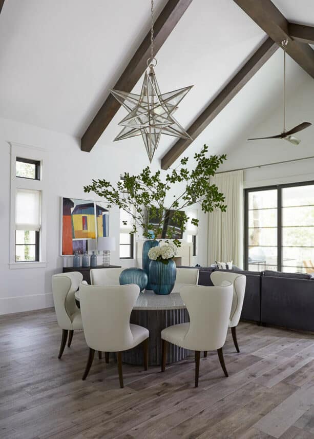 dark finished exposed beam in a white vaulted ceiling