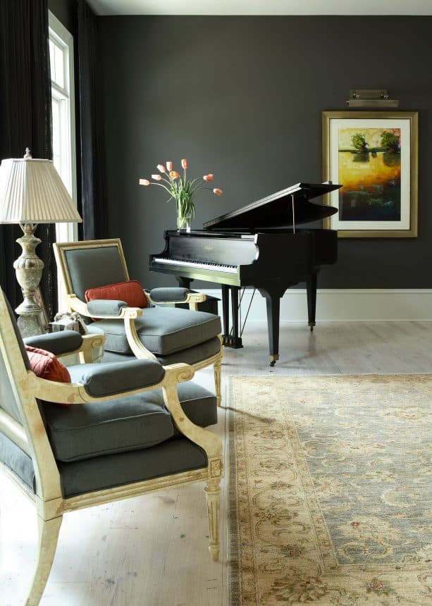 traditional living room with charcoal grey walls and pine wood floor