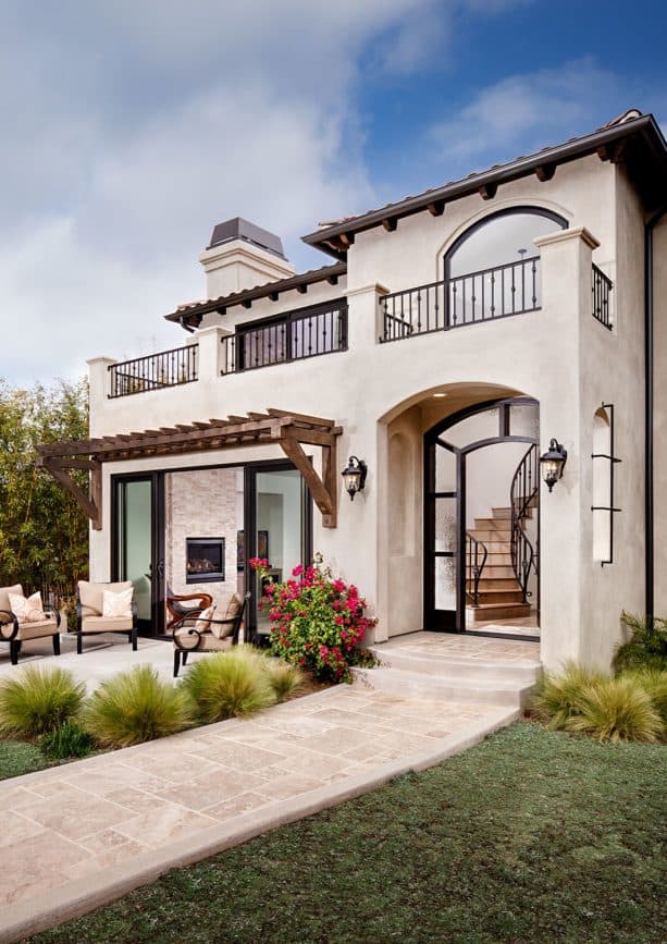 the use of chiffon white stucco and bronze trim in a Mediterranean exterior