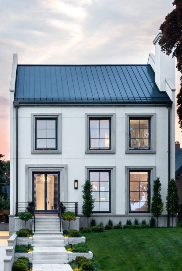 a contemporary two-story house with white stucco wall and grey trim