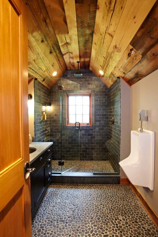 the combination of wood, stone, and tile in a man cave bathroom