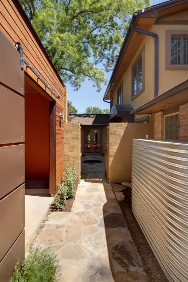 plywood and metal sliding barn door as a gate that offers strength and stability