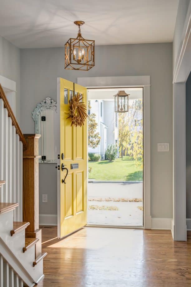 craftsman entry with grey walls, hardwood floor, and a yellow door