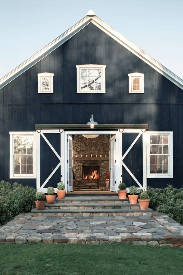 a hale navy blue benjamin moore barn styled front door in a rustic farmhouse property