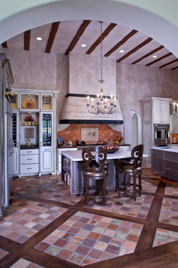 reclaimed terracotta floor tile trimmed by hickory with white cabinets to enhance a french country look