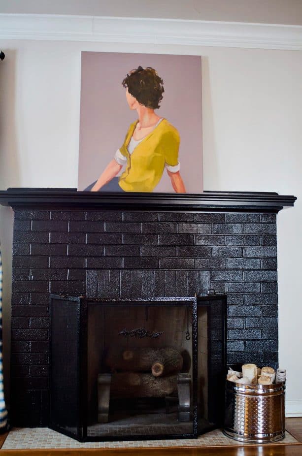 black brick fireplace with black mantel shelf