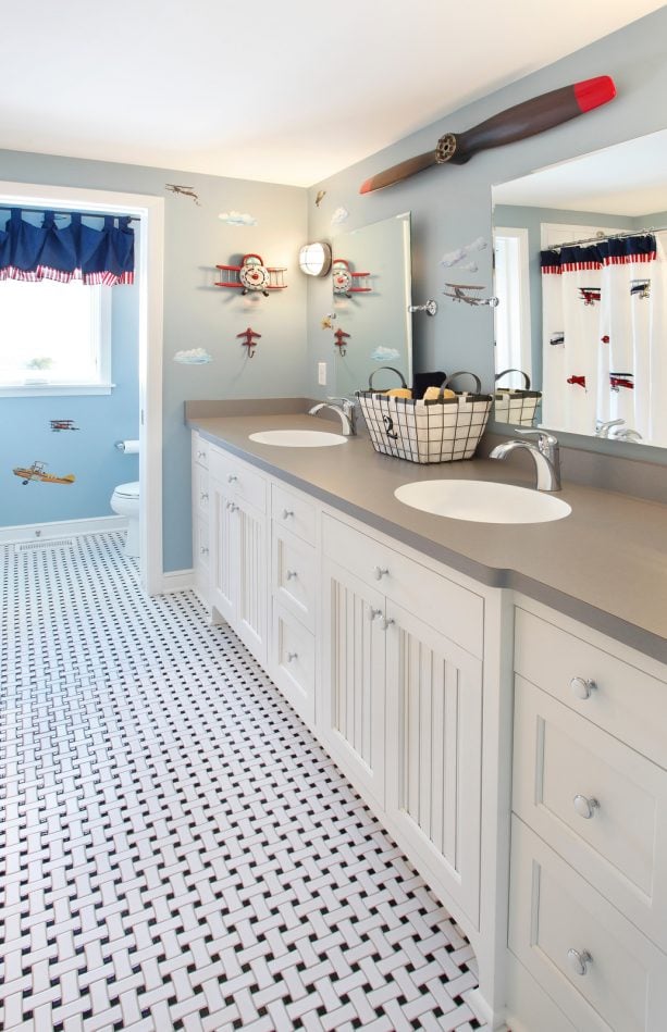 languid blue walls and a gray countertop make a cheerfully bright kids’ bathroom