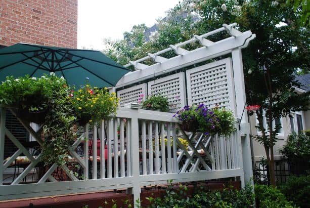 a special frame built behind the railing to hang the privacy screens