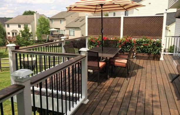 the combo of framed lattice and potted plants for deck rail screen