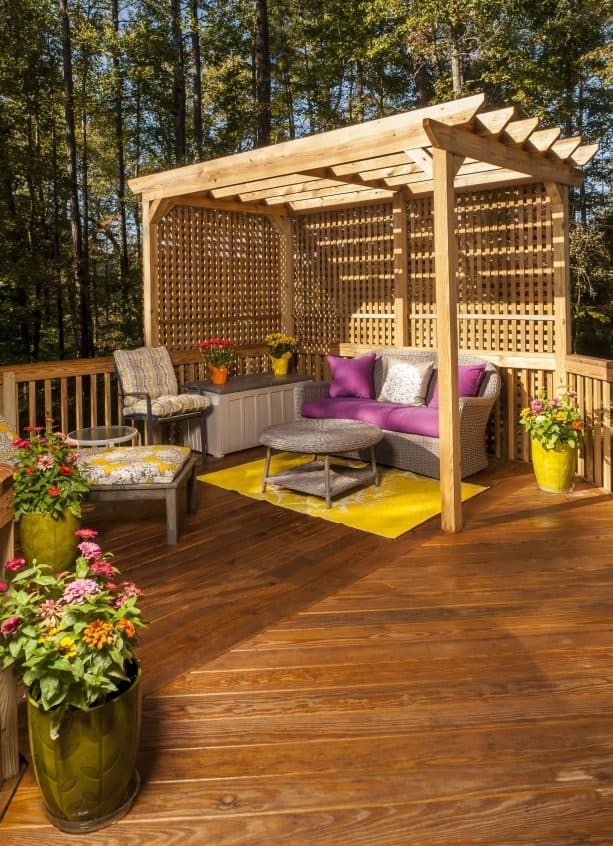 traditional deck with railing, lattice screen, and pergola